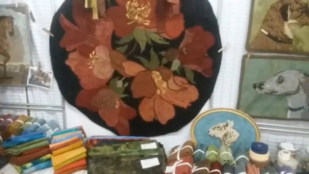 Rug hooking display and items for sale at the wool show.