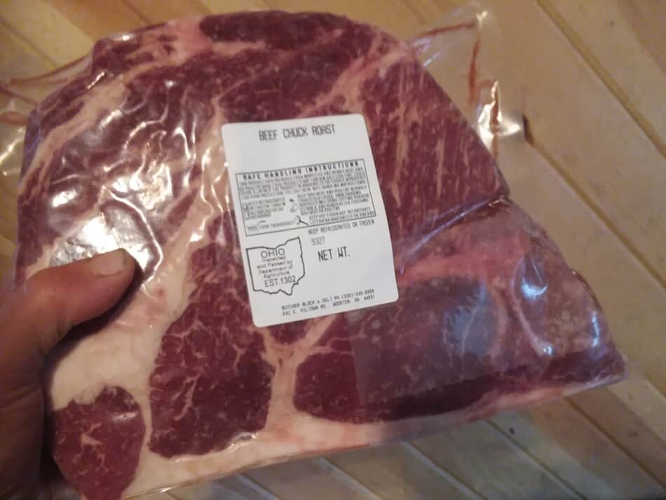 author holding beef chuck roast in  package